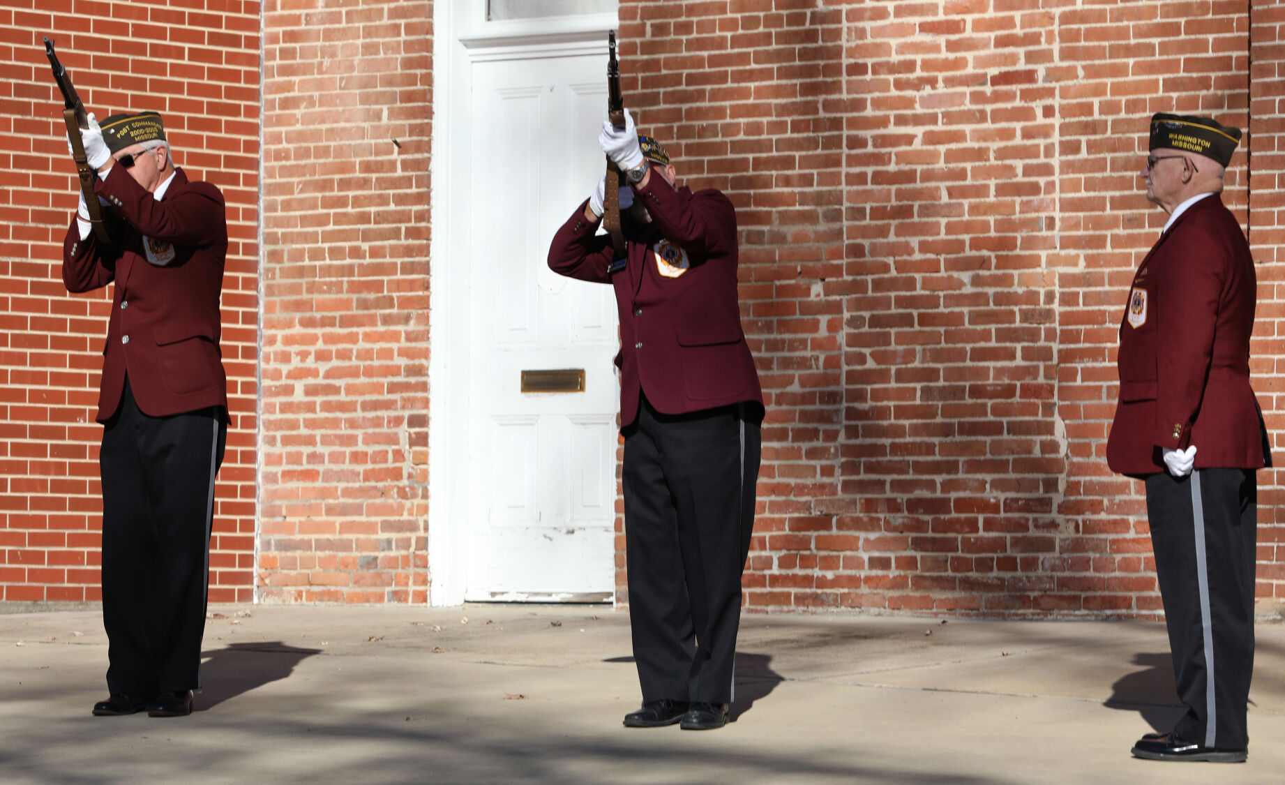 An honor guard performs a 21-gun salute